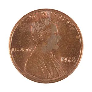A close-up of the obverse side of a 1973 Lincoln penny showing the profile of Abraham Lincoln and the inscriptions 'IN GOD WE TRUST', 'LIBERTY', and '1973'.