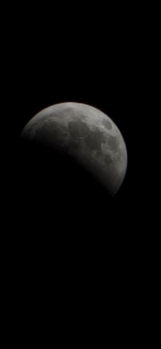 A waxing gibbous moon against a dark night sky.