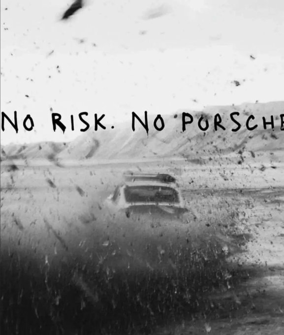 A black-and-white photo showing a car driving through a rugged, dusty landscape with debris flying toward the windshield, overlaid with the handwritten text "No Risk. No Porsche." The image reinforces the post's message by visually equating bold risk-taking with the high reward of a luxury Porsche, paralleling the crypto mindset that playing it safe in a volatile market guarantees missed gains.