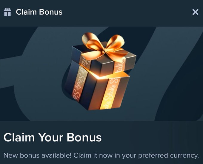 A "Claim Bonus" popup featuring a black gift box with gold ribbon and a glowing golden sparkle, accompanied by the text "Claim Your Bonus" and "New bonus available! Claim it now in your preferred currency." The image serves as a visual cue for the bonus drop announcement from the user's Stake.com promotion, inviting users to claim their premium gift via the Telegram channel.