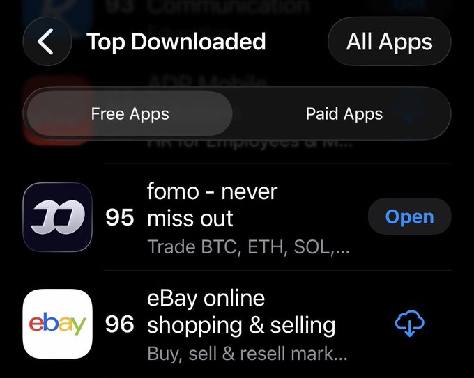 The image shows an app store's "Top Downloaded" list under the "Free Apps" tab, where "fomo - never miss out" (a crypto trading app for BTC, ETH, SOL) is ranked #95 and "eBay online shopping & selling" is #96. The "Open" button next to fomo confirms it has already been downloaded, illustrating the post's claim that fomo has broken into the top 100 free apps.