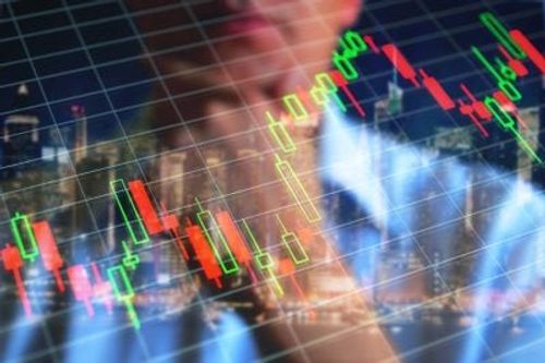 A stock photo showing a man in a suit overlaid with red and green candlestick chart patterns, symbolizing financial trading and stock market analysis.