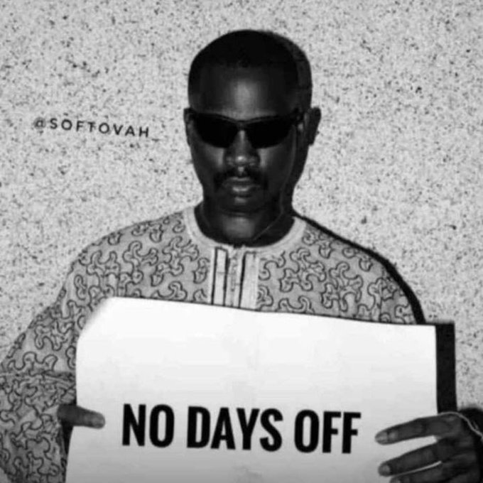 A black-and-white motivational image of a man in sunglasses wearing a patterned traditional shirt, holding a sign that reads 'NO DAYS OFF' with the handle '@SOFTOVAH' visible.