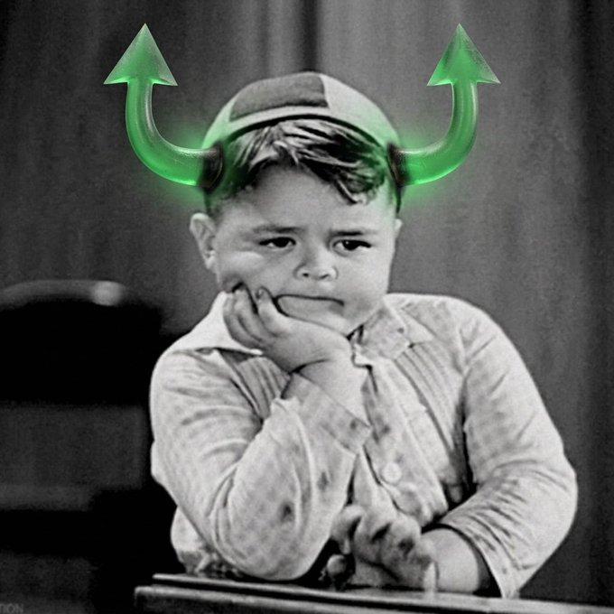 A black and white vintage-style portrait of a young child resting their chin on their hands, humorously edited with glowing green devil horns and upward-pointing arrows digitally added to the image.