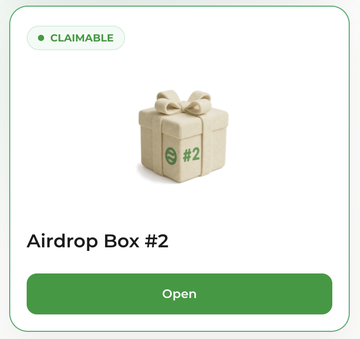 The image shows a digital "Airdrop Box #2" labeled as "CLAIMABLE," featuring a cream-colored gift box with a bow and a green "Open" button beneath, indicating users can now claim their $DOS token airdrop from DAPPOS via dappos.com/airdrop.
