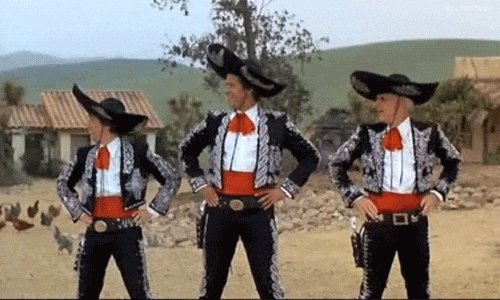 The image features three men dressed in traditional Mexican costumes with sombreros and red shirts, standing next to each other against a backdrop of a field or desert landscape. The men appear to be posing for a photo, possibly as part of an online community or social media account dedicated to Mexican culture or traditions.