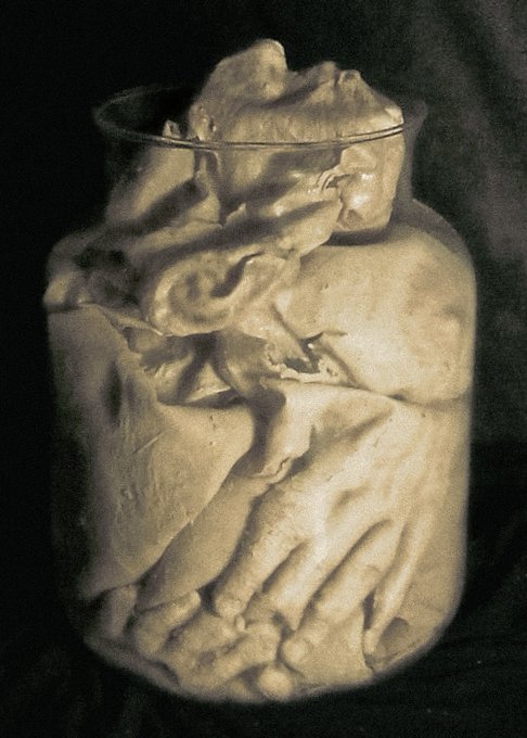 A sepia-toned, textured image of a glass jar filled with what appears to be crumpled fabric or organic matter, rendered in a sculptural, almost classical style.
