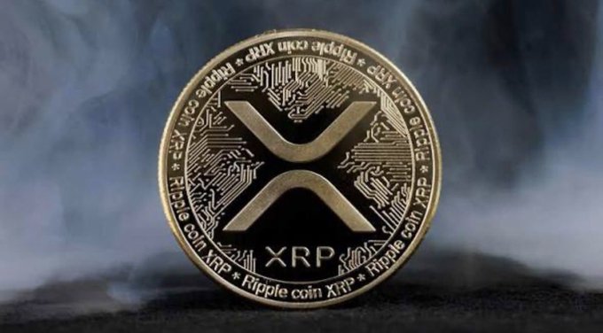 A close-up of a physical Ripple (XRP) cryptocurrency coin with circuit board details and the XRP logo, surrounded by smoke.