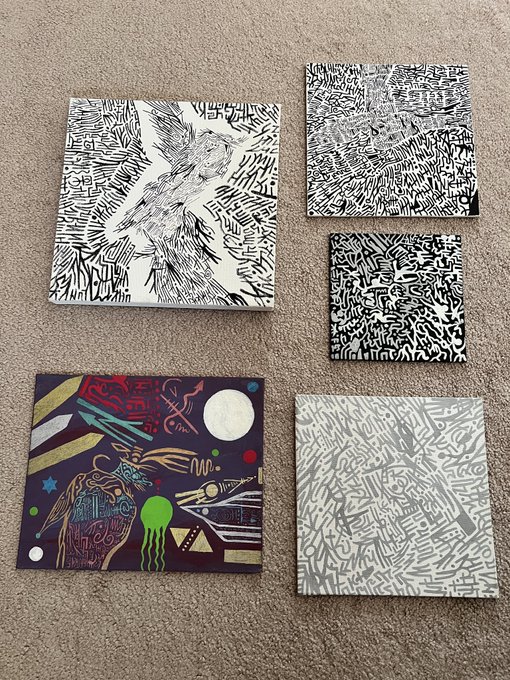 Five abstract graffiti-style paintings are arranged on a carpet, featuring dense black-and-white linework and one colorful cosmic scene. The post identifies the artwork as from @alien_inks, matching its otherworldly, alien-like imagery.