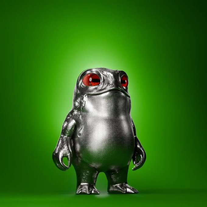 A metallic, chrome-like figure with a textured belly and glowing red eyes stands against a vibrant green background.