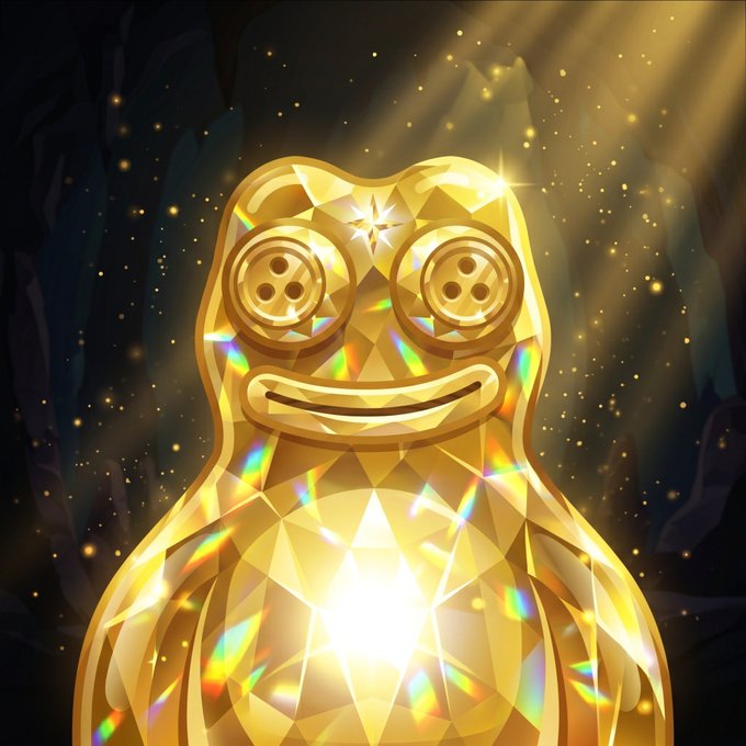 A shiny, crystalline golden figure with button eyes and a smiling face radiates rainbow light from its chest in a dark, cave-like setting.