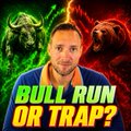 A YouTube thumbnail featuring a man in a blue suit with text 'BULL RUN OR TRAP?' against a green and red background with bull and bear imagery.