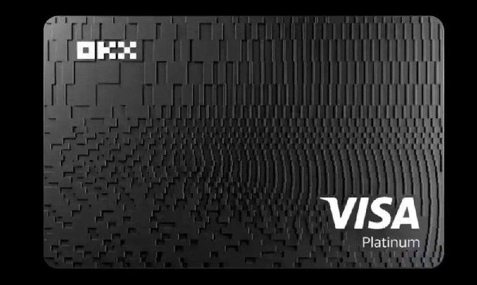 A sleek black OKX Visa Platinum card displayed against a dark background, featuring a textured geometric pattern. The image relates to a review of the OKX card service, highlighting the platform's competitive 0.15% USDT to USD conversion rate.