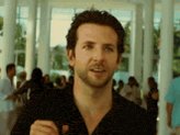 The image features a man with short hair wearing a black shirt, standing in front of a group of people who are also dressed in black shirts. They appear to be gathered together for an event or gathering. The background includes a white building that has columns, which adds architectural interest to the scene. The post caption reads "pre-rich", suggesting that this image might have been taken at a pre-rich party or social event where people are dressed similarly in black shirts and standing around each other.