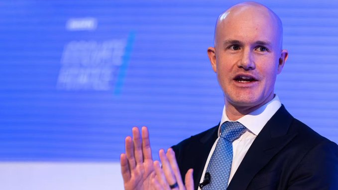 Coinbase CEO Brian Armstrong speaks at a "Future of Finance" event, gesturing during a presentation. The image relates to the accompanying post, which discusses Armstrong's public criticism of The Wall Street Journal over its coverage linking him and Coinbase to the failure of the CLARITY Act.