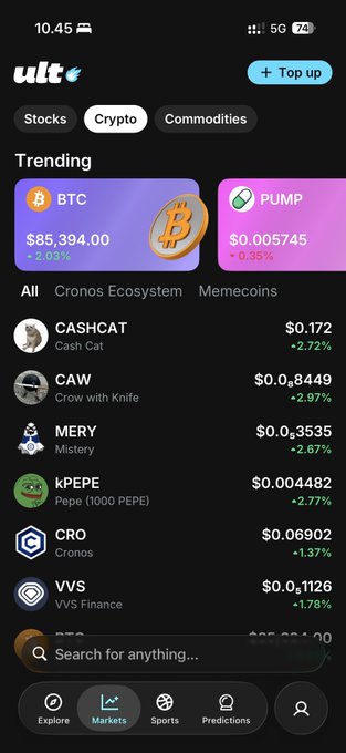 A mobile app screenshot of the "ult" platform showing cryptocurrency market data, with Bitcoin (BTC) at $85,394.00 and trending tokens including $PUMP, CASHCAT, CAW, MERY, KPEPE, CRO, and VVS.