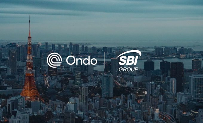 The image shows a twilight skyline of Tokyo featuring the illuminated Tokyo Tower, with the Ondo and SBI Group logos overlaid in the center. The visual reinforces the post's announcement of a partnership between Ondo Finance and SBI Group to tokenize Japanese assets and establish a global digital asset corridor using JPYSC, with the Tokyo backdrop symbolizing the Japan-based collaboration.