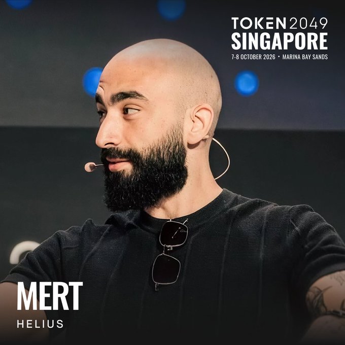 The promotional image features Mert, CEO of Helius, speaking at a conference with a headset microphone, advertising his appearance at TOKEN2049 Singapore from 7-8 October 2026 at Marina Bay Sands. The image directly supports the post's announcement of his return to the event, highlighting his prominence in the Solana ecosystem and his expanding work into Zcash privacy initiatives.