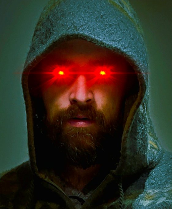 A stylized image of a bearded man in a hooded jacket, with glowing red laser-like eyes obscuring his vision.