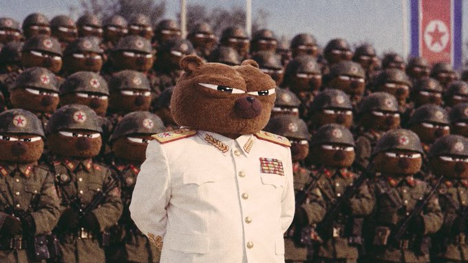 A commanding brown bear in a white military uniform stands at attention in front of rows of helmeted bear soldiers wearing green uniforms with red star insignias, while a North Korean flag is visible in the background. The image visually reinforces the post's theme of strength and authority, tying into the bullish "$BOBO" ticker sentiment.