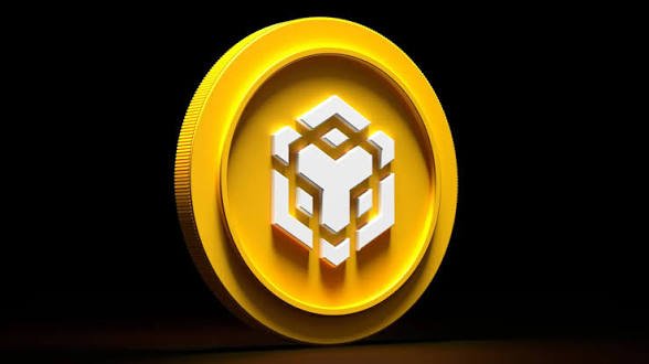 A 3D-rendered golden BNB (Binance Coin) token against a dark background.