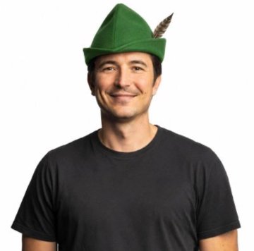 A smiling man wearing a plain black t-shirt models a green felt Robin Hood-style hat with a feather attached to the side.