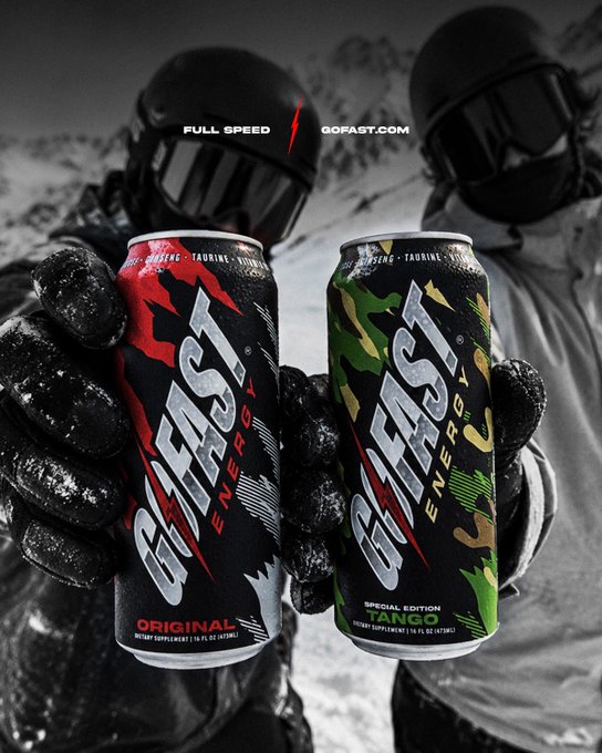 Two cans of 'G FUEL BEAST ENERGY' are held by gloved hands, featuring red and green camouflage designs for 'Original' and 'Special Edition Tango' flavors, with 'FULL SPEED' and 'GOFUEL.COM' text.