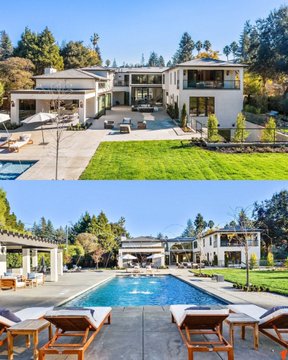 A modern, two-story white house with a large green lawn, patio area, and swimming pool surrounded by trees.