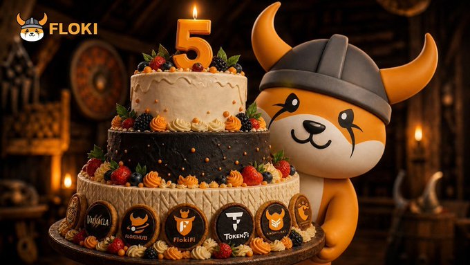 A celebratory 5th-anniversary cake is decorated with "FLOKI" and the number "5" candle, alongside cookie medallions featuring the logos of Floki, Valhalla, FlokiFi, and TokenFi, with the Floki mascot wearing a Viking helmet peeking from behind—visually marking the milestone of $FLOKI's longevity in the volatile memecoin space.