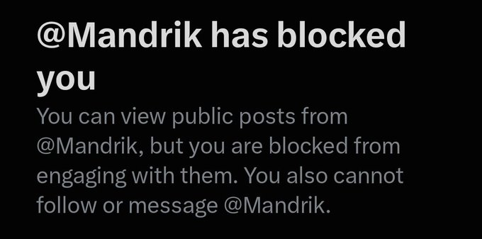 A notification screen showing '@Mandrik has blocked you' with a message explaining that public posts can be viewed but engagement, following, and messaging are restricted.