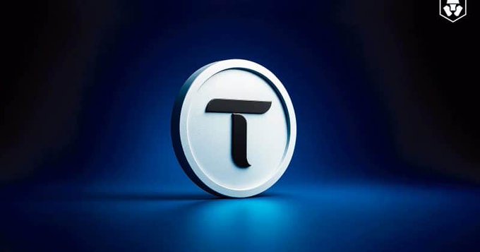 A stylized 3D rendering of the Bittensor "τ" (TAO) logo glows against a dark blue gradient background, representing the cryptocurrency at the center of Kraken's latest listing announcement for decentralized AI subnet tokens like Chutes AI and Targon Compute.