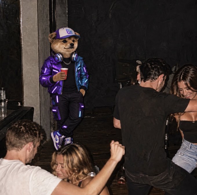 A person wearing a teddy bear mascot costume with a purple and blue iridescent puffer jacket, headphones, and cap holds a red cup while standing near people dancing at a nightclub.