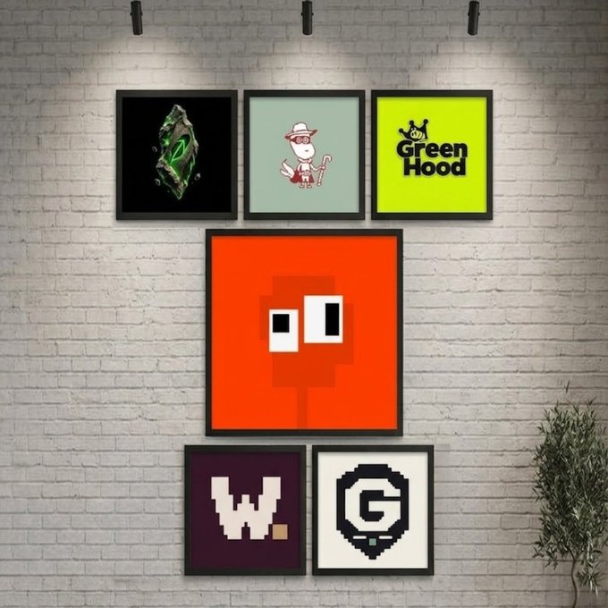 A wall display of framed NFT/crypto art posters including a green crystal, a character with a cane, 'Green Hood', a red blocky character, 'W.', and a 'G' pixel art logo.