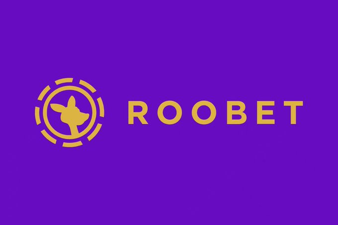 The image displays the Roobet logo, featuring a yellow chicken silhouette within a circular target design alongside the "ROOBET" text on a purple background. This branding matches the post's reference to Roobet, the casino operator behind the popular "Chicken Game."