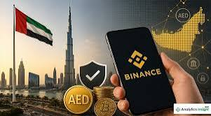 The image features the UAE flag, the Burj Khalifa skyline, golden "AED" coin badges, and a hand holding a smartphone displaying the Binance app, visually connecting the UAE dirham and Binance's crypto services. It illustrates the post's message about how AED transfers and the Binance Card integrate digital finance into everyday life for eligible UAE users.