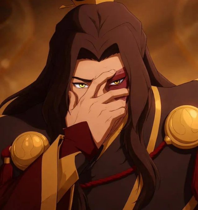 An animated character with long dark hair and green eyes looks through his fingers, wearing dark robes with gold accents and large gold shoulder ornaments against a fiery background.