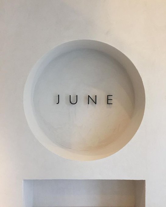The image features a white wall with the word "June" written in black letters, which appears to be part of an art installation or creative display. The text "good morning frens have a great day believe in Hyperliquid" is also present on the same wall. This combination of elements creates a unique and thought-provoking visual experience for viewers who come across this image.