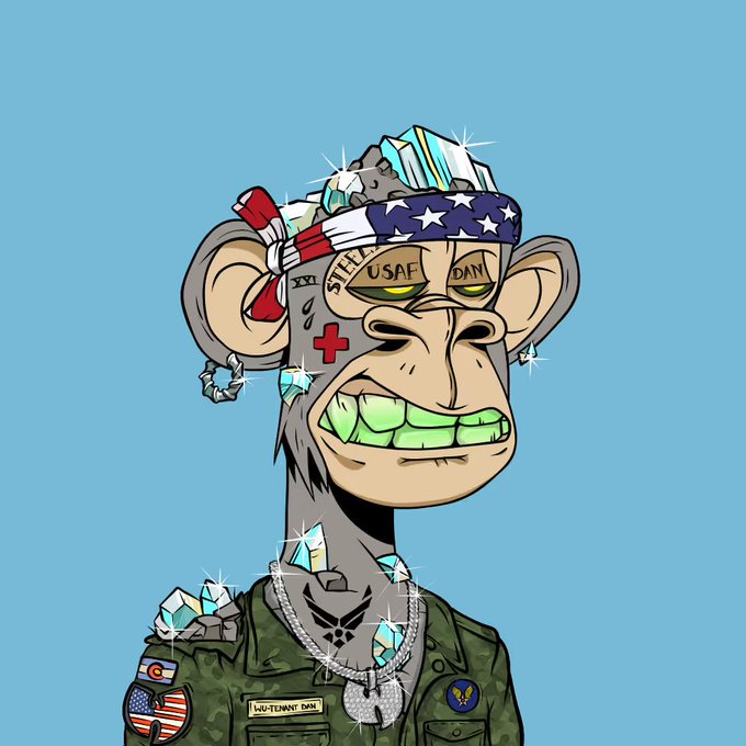 A cartoon-style illustration of a gray monkey with green diamond teeth, wearing a USA-themed headband, military uniform, and diamond-studded accessories on a light blue background.
