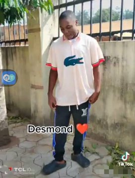 A TikTok video screenshot of a man named 'Desmond' wearing a white Lacoste polo shirt and dark pants, standing outdoors in front of a gate.