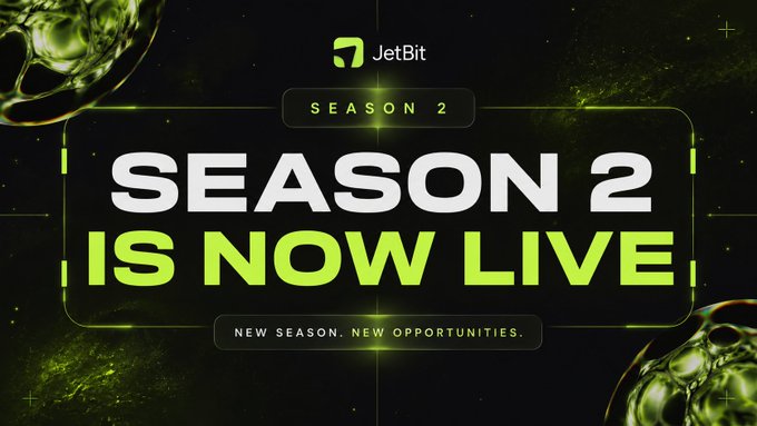 A promotional graphic for JetBit announcing "SEASON 2 IS NOW LIVE" in bold green and white text against a dark background, with the tagline "NEW SEASON. NEW OPPORTUNITIES." displayed below, matching the post's call to action to start trading at jetbit.com.