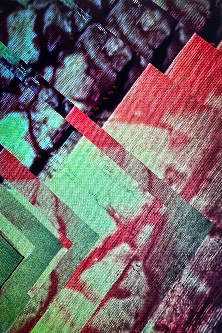 An abstract collage of layered, textured panels in red, green, and dark tones with streaks and geometric patterns.