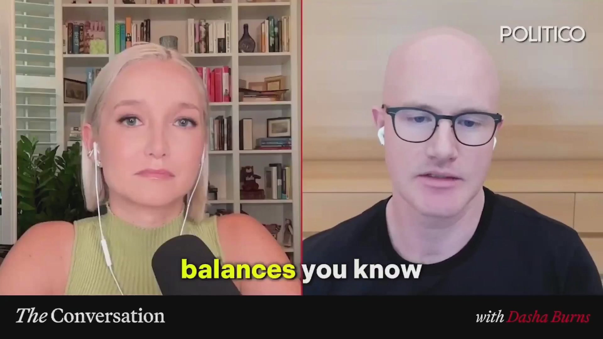 The image shows a man wearing glasses with a bald head, sitting next to a woman who has blonde hair. They are both talking into microphones during an interview or discussion. The background of the image features a bookshelf filled with various books.