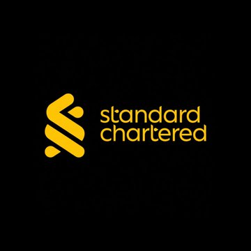 The image displays the Standard Chartered logo—featuring its signature intertwined arrow symbol in yellow alongside the lowercase text "standard chartered"—on a dark gray background, visually branding the bank's announcement of launching Bitcoin and Ethereum trading services for UAE clients under VARA licensing.