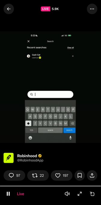 The image shows a live stream screenshot featuring the Robinhood App's search bar with "Cash Cat" (@cashcat) listed under recent searches, with 5.9K live viewers and a Robinhood tweet posted by @RobinhoodApp showing 97 comments, 22 retweets, and 197 likes. This appears to celebrate the $CASHCAT ticker's debut on the Robinhood platform, as indicated by the accompanying caption "HEY $CASHCAT LOOKS GOOD ON YOU @RobinhoodApp."