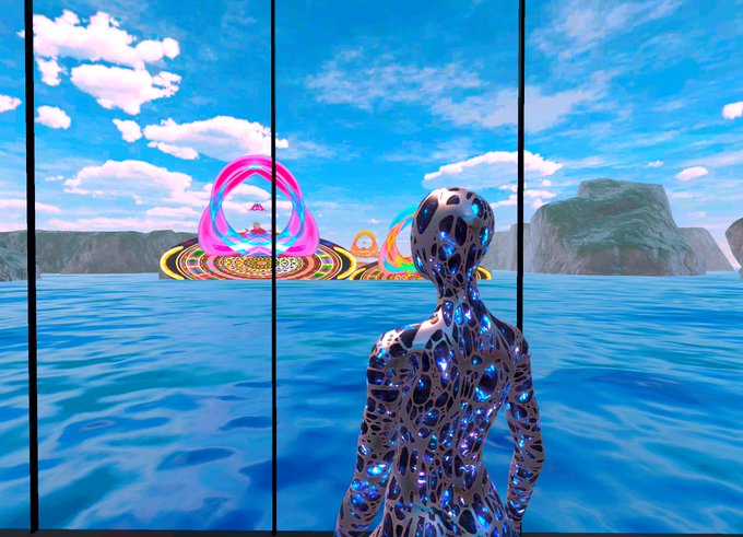 A chrome humanoid figure with glowing blue patterns stands overlooking a vibrant ocean scene featuring a colorful, ring-like floating structure in the distance, evoking the surreal and imaginative virtual worlds once crafted in the now-defunct @Spatial platform.