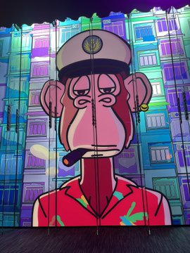 The image features a cartoon monkey wearing a hat, smoking a cigarette while standing against a colorful backdrop of buildings. The caption reads "Day 1 of posting ApeFest bangers until we get an announcement Take me back to ApeFest 2023 Hong Kong!!". This suggests that the image is part of a series or event related to ApeFest and is intended to draw attention to the upcoming event in Hong Kong.

The monkey's hat, smoking cigarette, and colorful backdrop create a playful and engaging visual experience for viewers. The caption serves as an invitation for people to come together and celebrate the unique artistry behind this image.