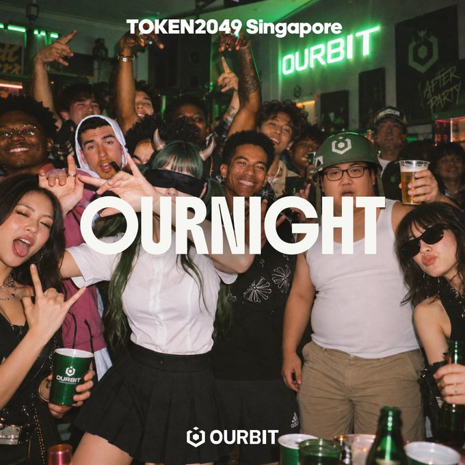 A lively crowd poses energetically at the Ourbit-sponsored OurNight party during TOKEN2049 Singapore, featuring text overlays "TOKEN2049 Singapore," "OURNIGHT," and the Ourbit logo. The scene captures the festive afterparty atmosphere the post promotes, with attendees holding drinks and making hand gestures in a neon-lit venue, embodying the "drinks, music, good people, and the Ourbit crew" theme of the Oct 7 event.