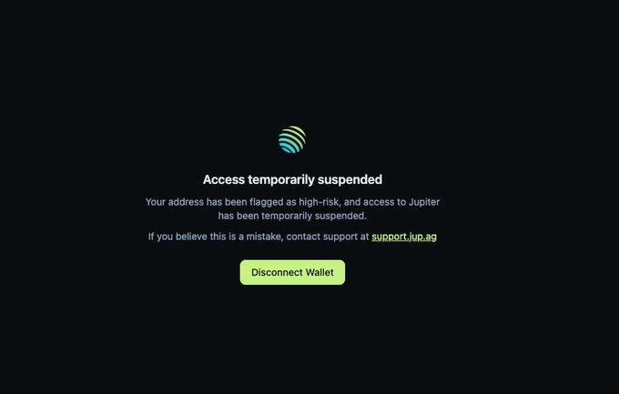 The image shows a Jupiter (JUP) platform notice stating "Access temporarily suspended" because the user's wallet address was flagged as high-risk, with a green "Disconnect Wallet" button below. The screenshot illustrates the user's frustration about being banned from the Jupiter DeFi platform despite being able to simply reconnect with another wallet to withdraw funds.