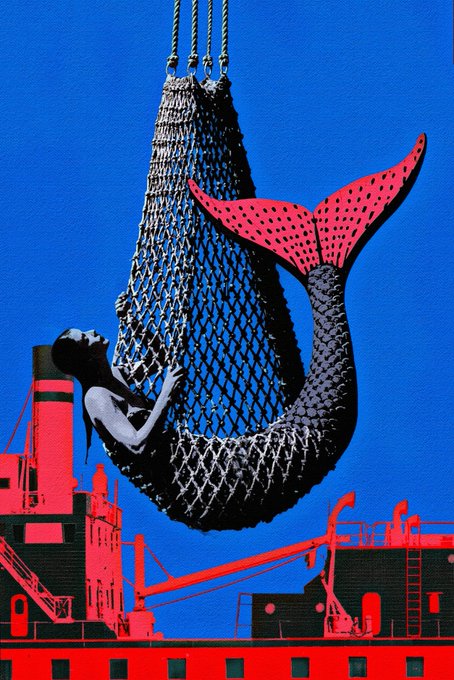 A surreal graphic illustration of a mermaid caught in a net being hoisted against a bright blue and red industrial/shipyard background.