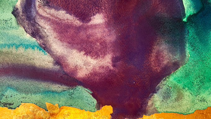 An abstract painting or texture featuring deep maroon/burgundy colors in the center surrounded by teal, green, and golden-yellow hues with a rough, painterly finish.